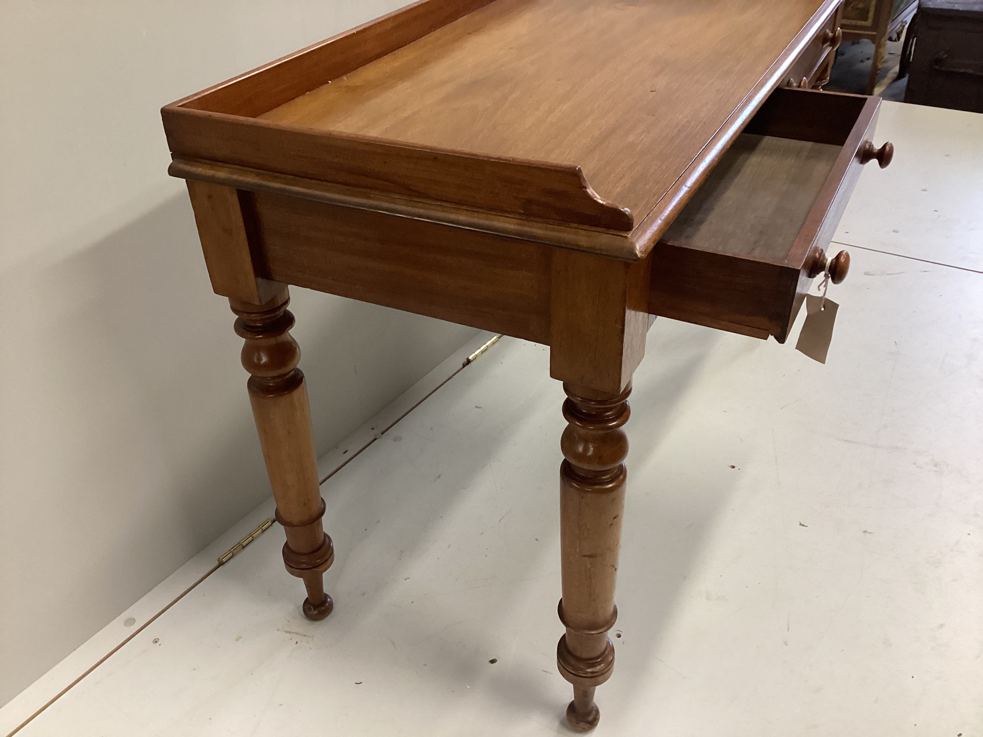 A Victorian mahogany two drawer writing table, width 120cm, depth 50cm, height 76cm